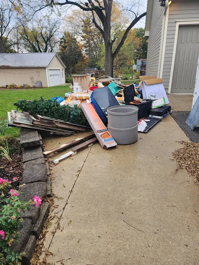 Dumpster being loaded with debris for 10 Yard Dumpster Rental in Mequon